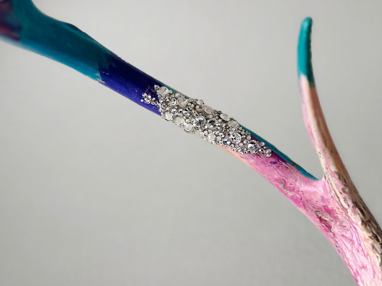 image of large real white tail deer antlers colorfully hand painted, mounted and covered in pastel neon green and pink cheetah leopard print fabric